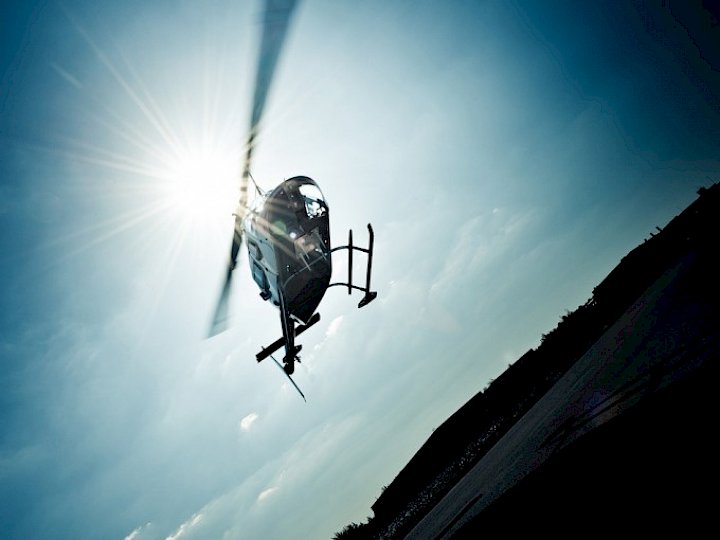 Hubschrauber im Landeanflug im Gegenlicht